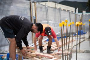 Builders arranging timber
